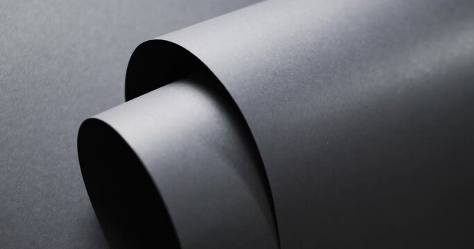 Close up of rolls of black paper and copy space on black background