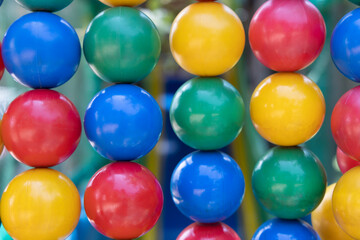 colored balls in a continuous series, which form a colored wall of blue, red, green and yellow almost forming a rainbow