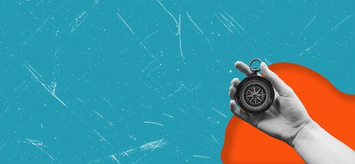 Compass in a man's hand. Business development in different directions.