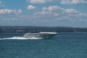Big white motor white boat moves fast on blue water. Super fast White fifteen-meter boat moving...