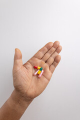 Four pill capsules  in the hand.