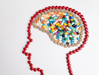 head with mark and brain made from medicine pills.