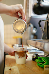 Barista preparing iced latte