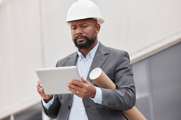 Tablet, blueprint and an architect manager planning a development project for commercial property. Technology, research and construction with a black man manager reading a floor plan design online