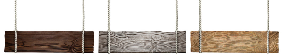 Set of wooden signs hanging on ropes, on white