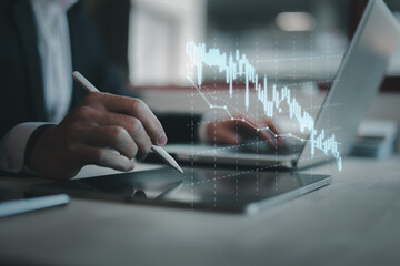 Hand of Businessman or trader touching showing a growing virtual hologram stock on Laptop, Concept...