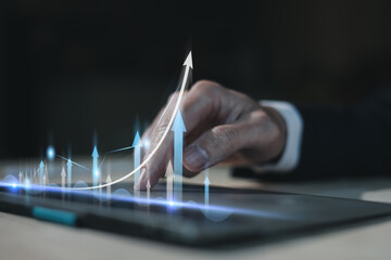 Hand of Businessman or trader touching showing a growing virtual hologram stock on Laptop, Concept...