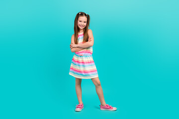 Full length photo of positive glad girl wear stylish clothes two arm folded posing promoting store mall isolated blue color background