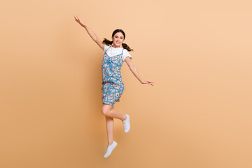 Full length cadre of relaxed girl jump high flying wings have fun overjoyed enjoy summertime...