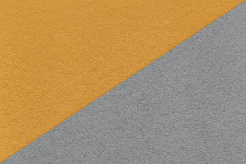 Texture of craft dark orange and gray paper background, half two colors, macro. Vintage kraft grey cardboard.