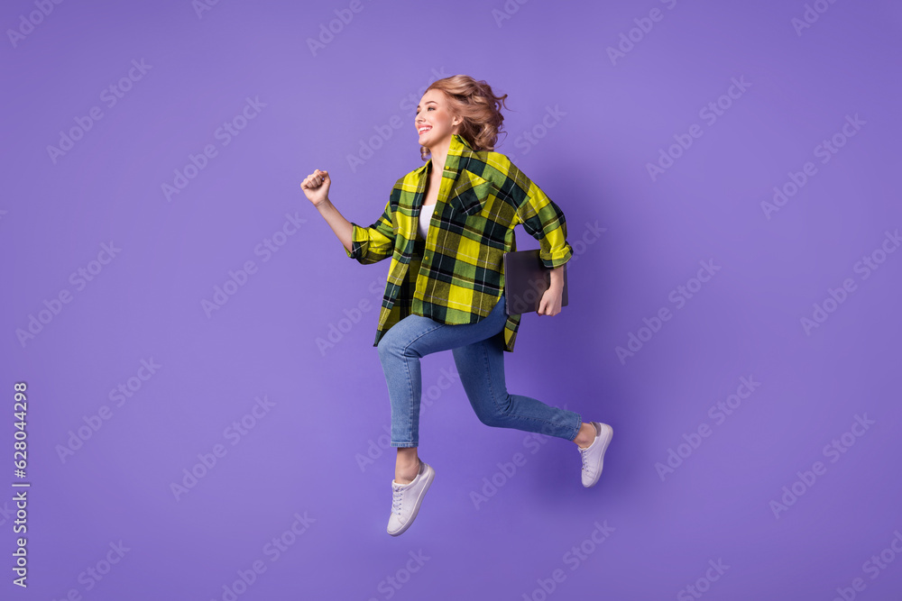 Poster Full body photo of running funky woman blonde curls go with netbook senior it specialist python coder isolated on purple color background