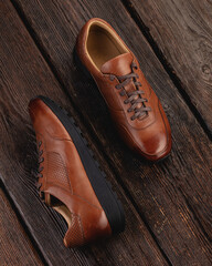 Modern street shoes stand stone on stone against a gray background