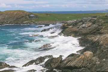 large waves of the North Sea crash on a rocky coast in Norway