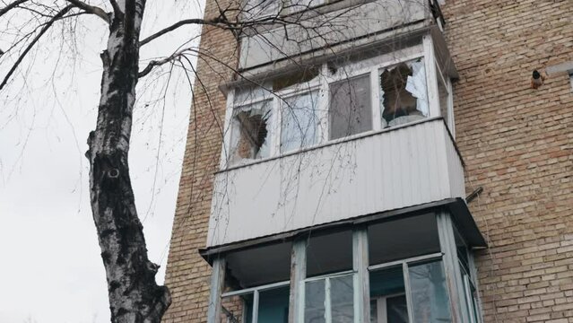 Smashed window, broken glass, Destroyed building. Building had smashed windows, broken frames, broken glass. Building bombed, window broke, glass damaged apartment, caused significant damage to house