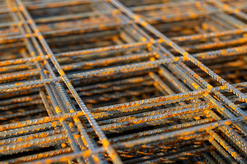 Stack of welded wire mesh, WWM, ready to be installed within a sidewalk concrete form. 