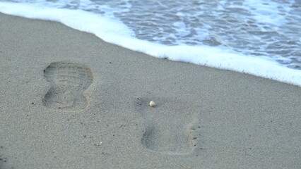 footprints in the sand on the beach