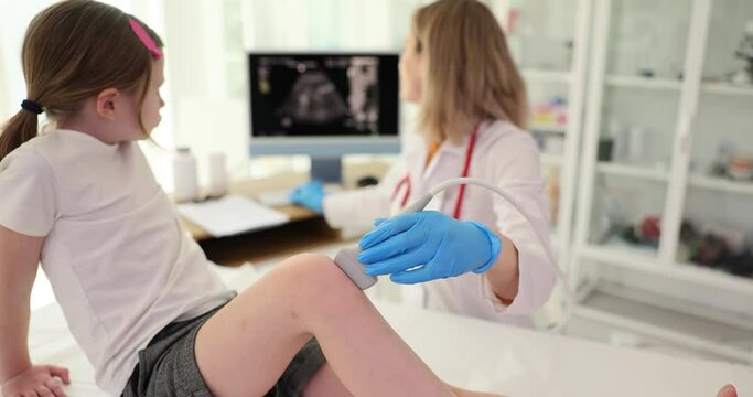 Girl with orthopedic medical ultrasound of knee. Diseases of the skeletal system and diseases of joints in children