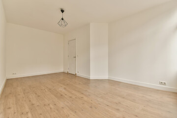 an empty room with wood floors and white walls, the door is open to reveal a large window in the corner