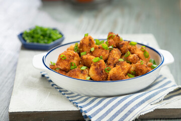 Freshly made spicy chicken nuggets in a bowl.
