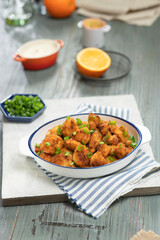 Freshly made spicy chicken nuggets in a bowl.
