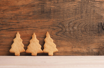 Three tasty organic Christmas cookies on a rustic wooden board, Christmas bakery