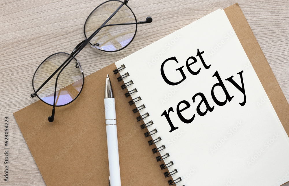 Poster get ready flat lay, top view. text written on open notebook on wooden background