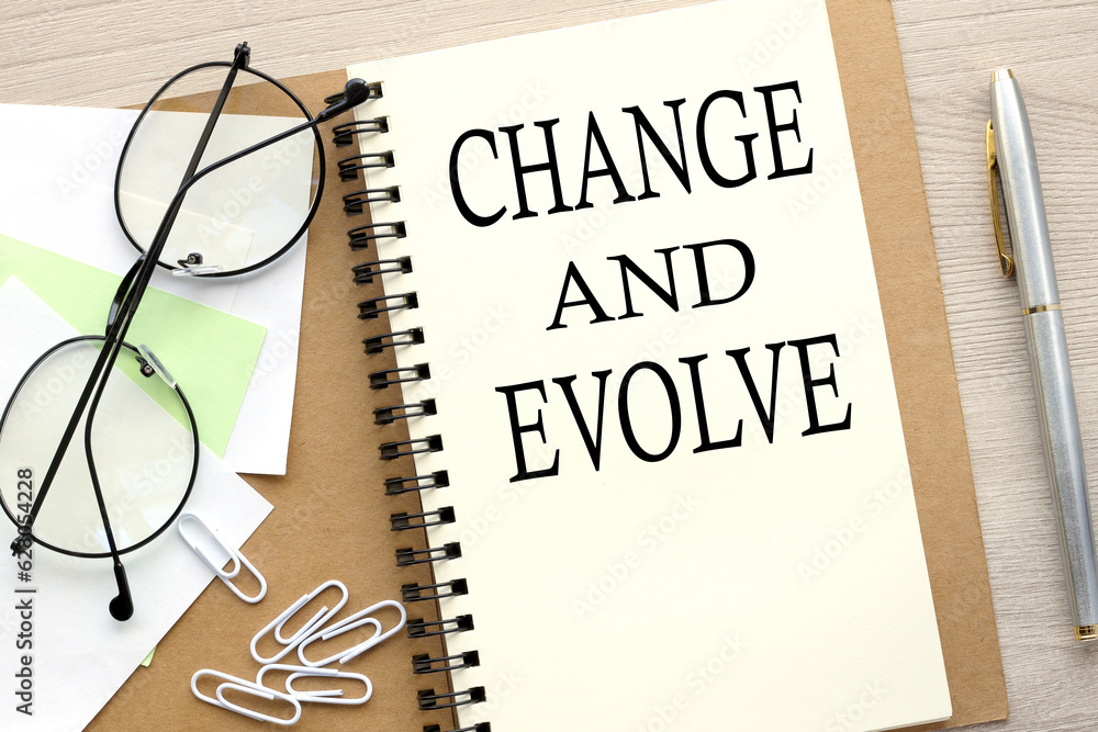 Poster change and evolve open notebook with stickers and glasses .word on page