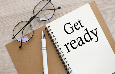 GET READY Flat lay, top view. text written on open notebook on wooden background
