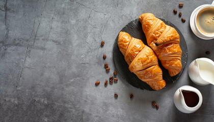 Coffee and croissant on stone table. French breakfast. Top view flat lay with copy space for your...