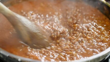 The cook prepares lentils stew in the pan.
 - Powered by Adobe