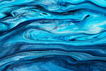 Blue flowing paint texture. Marbled paper abstract background