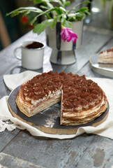 Freshly prepared delicious tiramisu crepe cake on the table.

