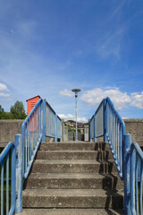 Concrete stairway with metal handrails. Urban scene, sunny summer day, no people