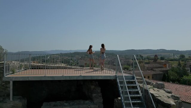 Two adults one child climb stairs to look at village of Calders, Catalonia