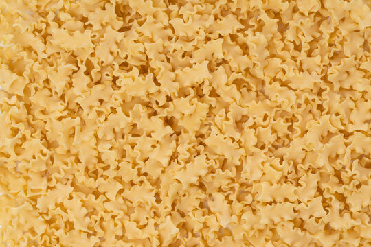 Background image with dry mini lasagna noodles with copy space
