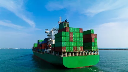 Poster wide angle shot rear view of cargo container ship sailing in sea blue sky background to import export goods and distributing products to dealer and consumers worldwide, by container ship Transport  © SHUTTER DIN