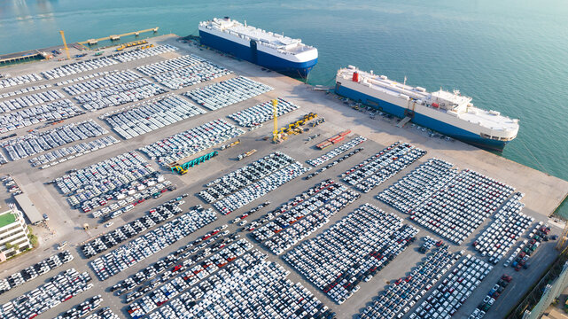 aerial view of new cars parked at the parking area of automobile factory, waiting for RORO transport of international,