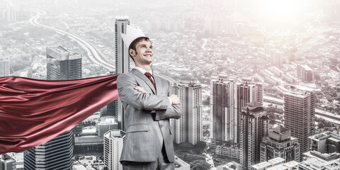 Concept of power and sucess with businessman superhero in big city