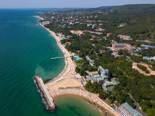 aerial view of Bulgaria's Golden Sands resort during the summer season: an array of hotels, pools, and crowds of people enjoying the sea.