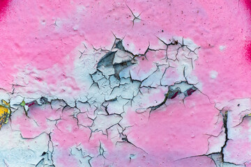 Obraz premium Close up of the colorful cracks and chips of an old wall.
