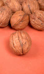 Closeup photo of a walnut seed in wooden bowl. Food that is good for brain and lower risk of heart disease.