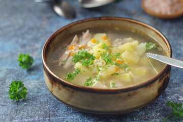 A bowl with chicken soup with pasta