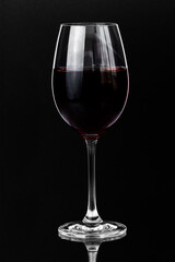 Red wine in a glass on a dark background with copy space.