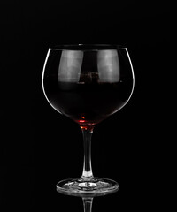 Glass of red wine on dark background. Happy hour and nightlife. Bar and restaurant.