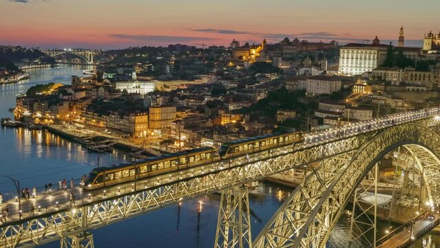 Sunset evening view of Porto, Portugal. Zoom out view of old city in Porto and bridgePonte Luis I with citylights