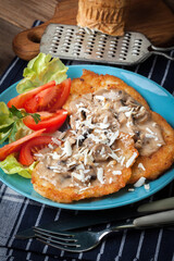 Crispy fried homemade potato pancakes with mushroom sauce.