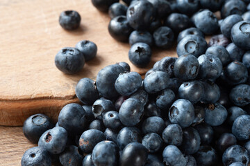 Blueberryies Fresh blueberry on a wooden table close-up. Sprinkle blueberries. Scattered fresh blueberries. Organic food on a wooden table. Selective focus