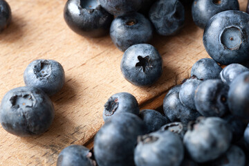 Blueberry. Fresh blueberries on a wooden table close-up. Sprinkle blueberries. Scattered fresh blueberries. Organic food on a wooden table. Selective focus