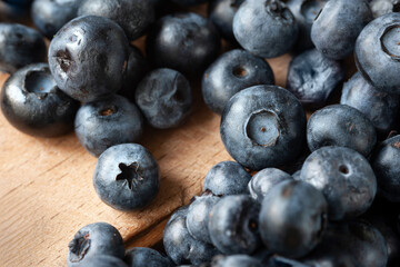 Blueberry berries. Fresh blueberries on a wooden table close-up. Sprinkle blueberries. Scattered fresh blueberries. Organic food on a wooden table