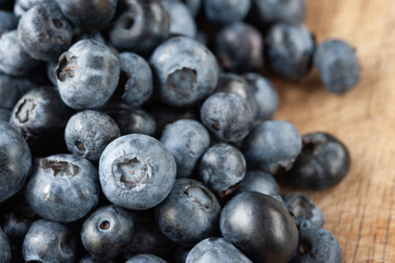 Blueberry berries. Fresh blueberries on a wooden table close-up. Sprinkle blueberries. Scattered fresh blueberries. Selective focus